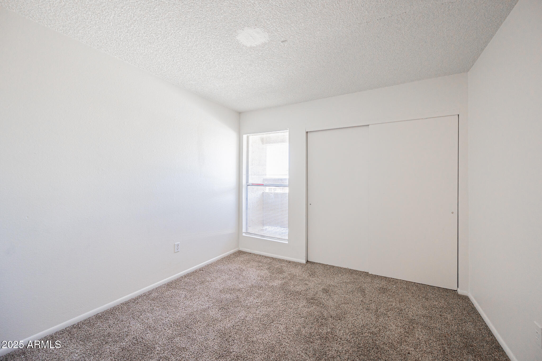 2802 North 43rd Avenue, Unit B Phoenix, AZ 85009 - Photo 13 of 18 an empty room with an empty space