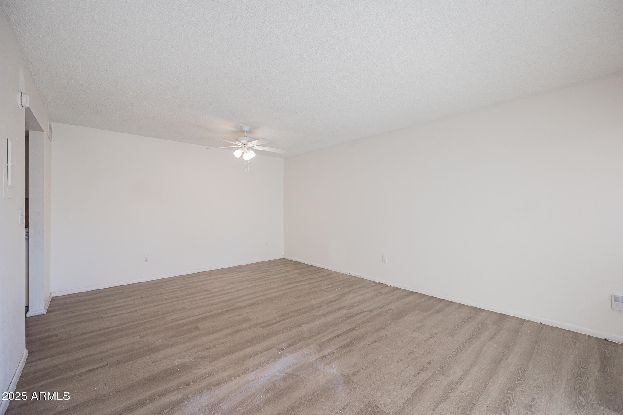 2802 North 43rd Avenue, Unit B Phoenix, AZ 85009 - Photo 6 of 18 a view of empty room with wooden floor