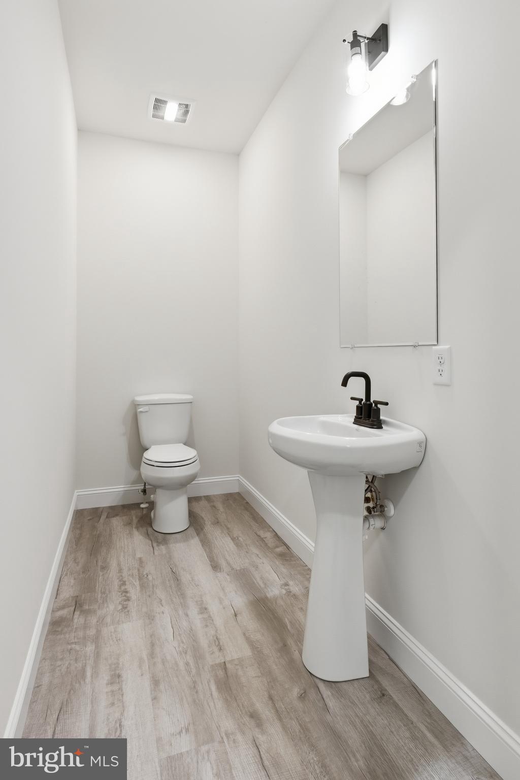 1354 College Road Dover, DE 19904 - Photo 10 of 46 a bathroom with a sink toilet and a mirror
