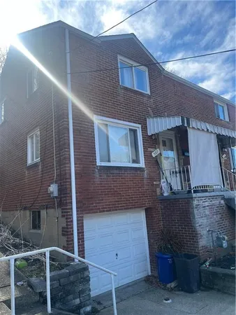 a front view of a house with parking