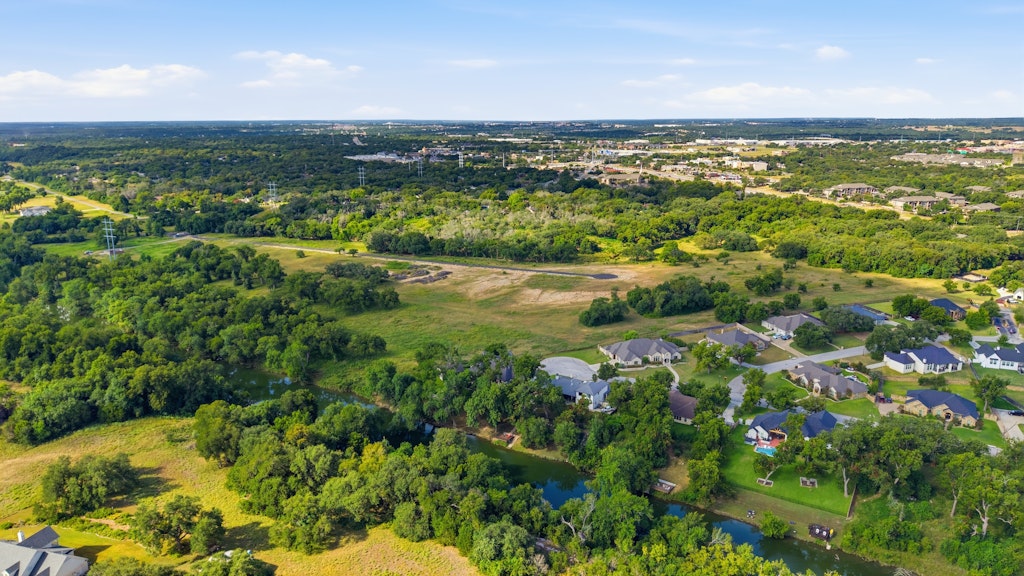 Tbd Tbd Belton, TX 76513 - Photo 7 of 16 An aerial perspective showcases private residential properties bordering a serene waterway amid mature trees.