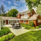 a front view of a house with yard porch and sitting area