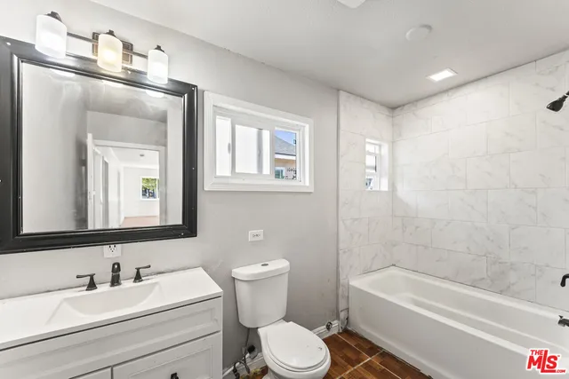 a bathroom with a toilet a sink and bathtub