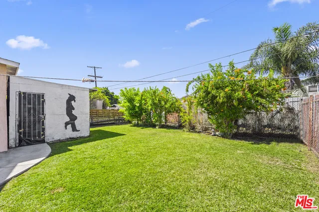 a view of a big yard with potted plants