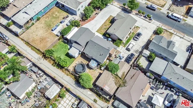 an aerial view of a house with garden space and street view