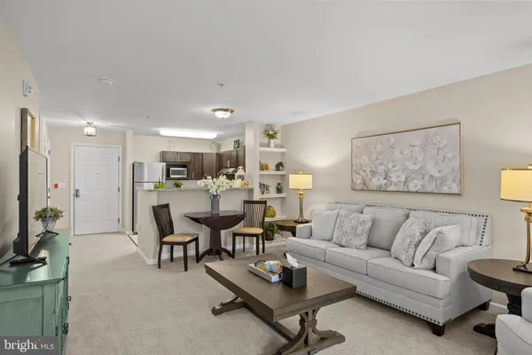 a living room with furniture kitchen view and a table