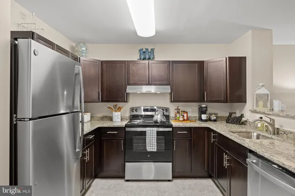 a kitchen with a stove sink and refrigerator