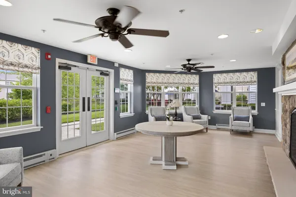 a view of a livingroom with furniture window and a kitchen space