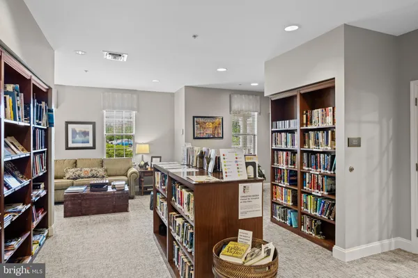 a living room with furniture and a book shelf