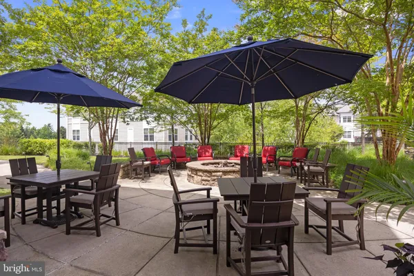 a view of patio with chairs and table under an umbrella