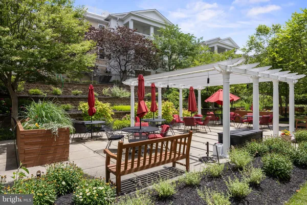 a view of a patio with couches table and chairs and potted plants