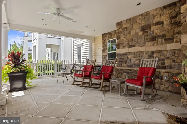 a view of a chairs with tables in patio