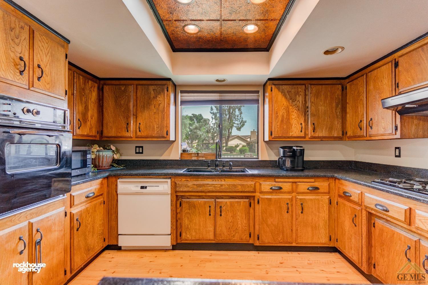 Undisclosed Address Bakersfield, CA 93308 - Photo 11 of 22 a kitchen with granite countertop a sink window and cabinets
