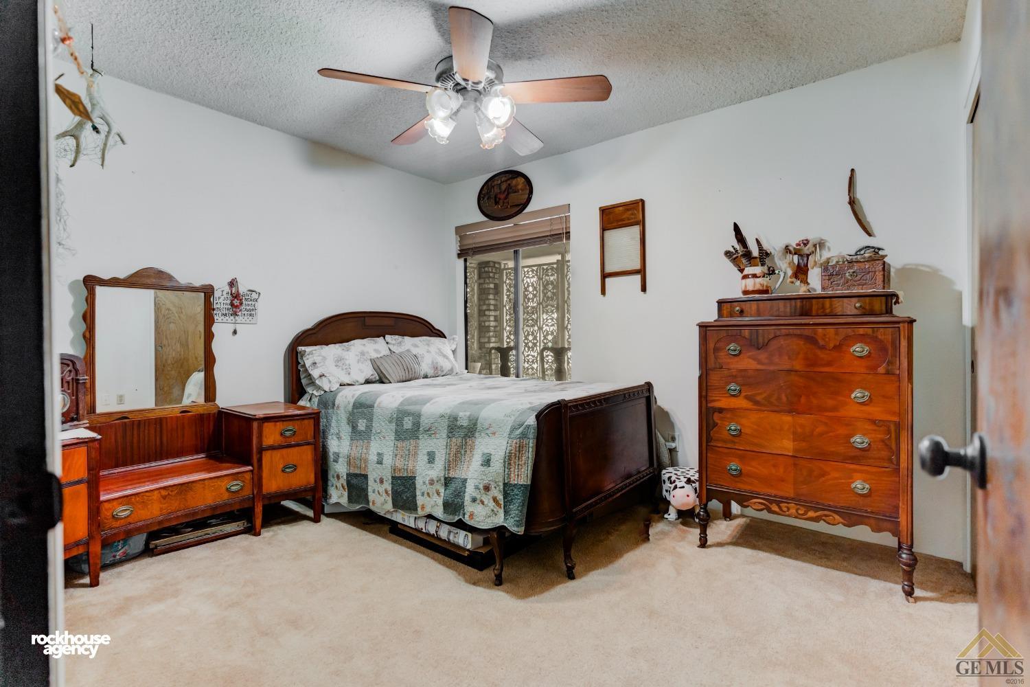 Undisclosed Address Bakersfield, CA 93308 - Photo 14 of 22 a bedroom with furniture and a ceiling fan