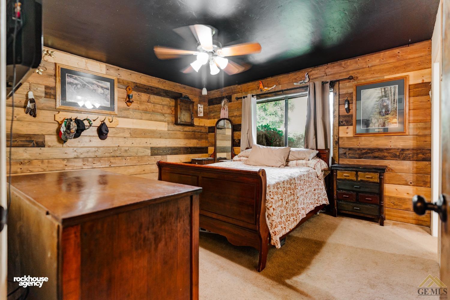 Undisclosed Address Bakersfield, CA 93308 - Photo 16 of 22 a bedroom with a bed and a chandelier