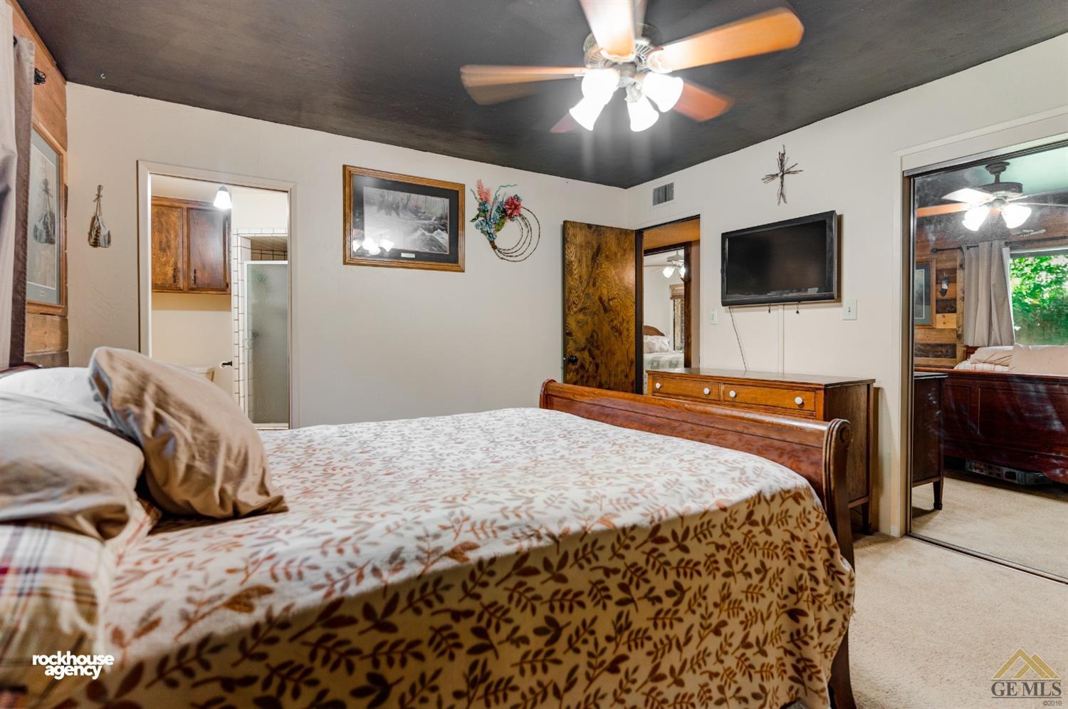 Undisclosed Address Bakersfield, CA 93308 - Photo 17 of 22 a bedroom with a bed and a flat screen tv