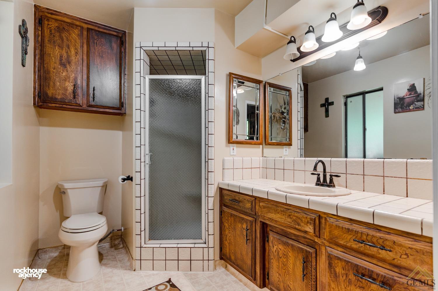 Undisclosed Address Bakersfield, CA 93308 - Photo 18 of 22 a bathroom with a toilet sink and mirror
