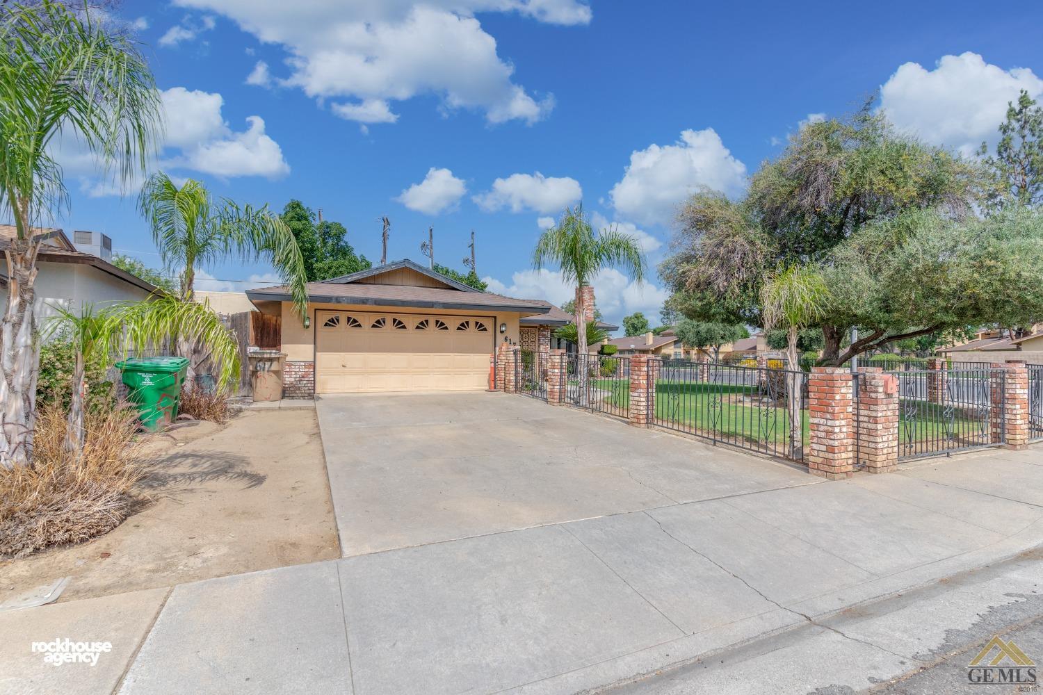 Undisclosed Address Bakersfield, CA 93308 - Photo 2 of 22 a view of a house with a yard and a garage