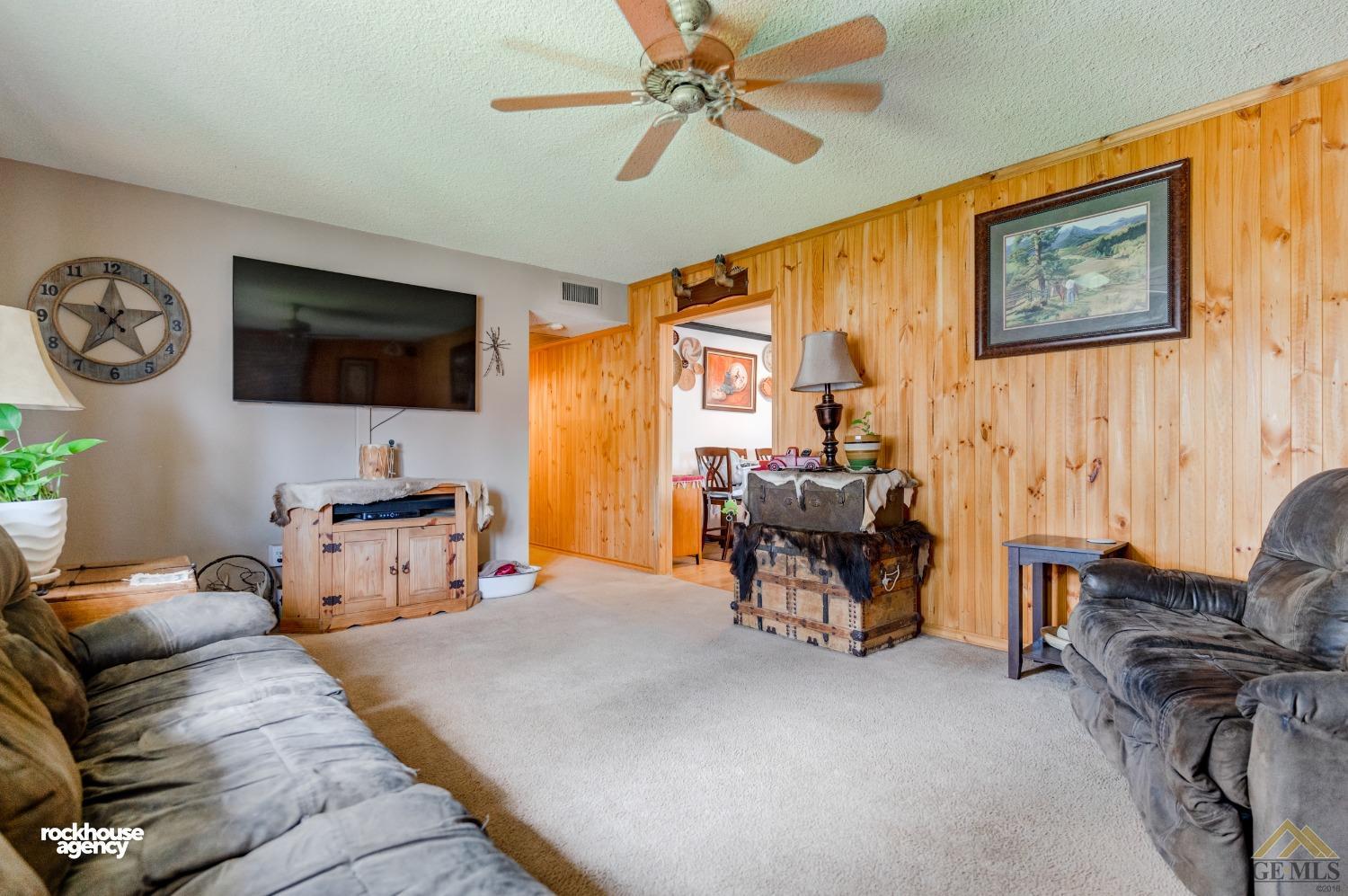 Undisclosed Address Bakersfield, CA 93308 - Photo 6 of 22 a living room with furniture and a flat screen tv