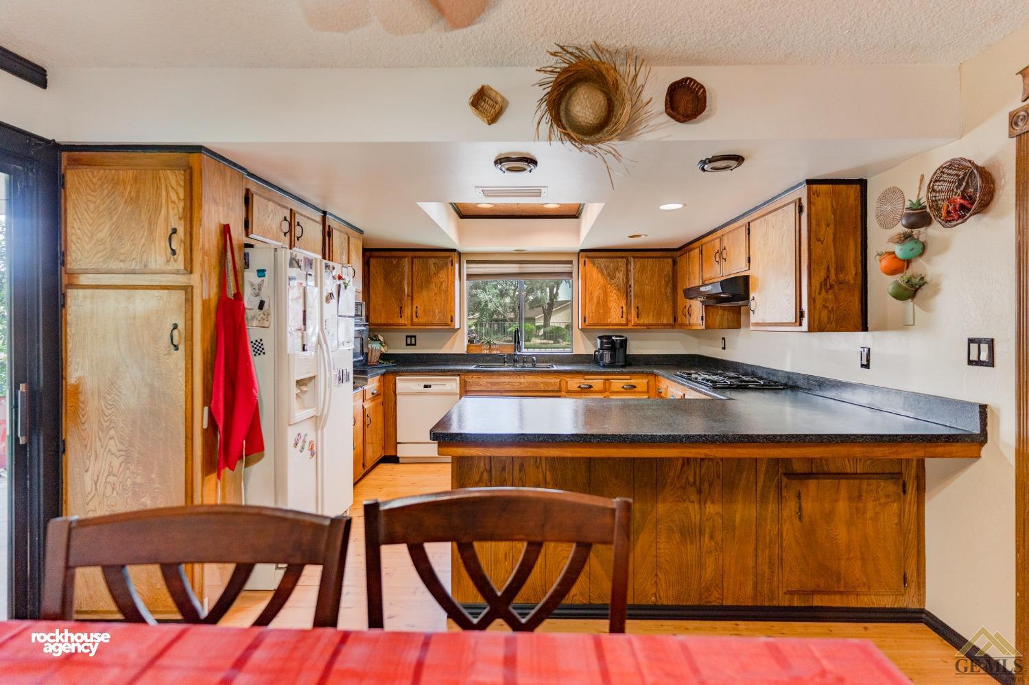 Undisclosed Address Bakersfield, CA 93308 - Photo 9 of 22 a view of a kitchen with stainless steel appliances granite countertop a stove and a refrigerator