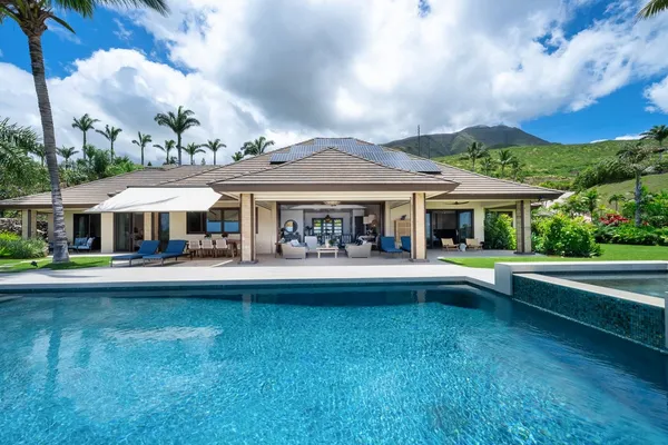 a front view of house with yard and outdoor seating