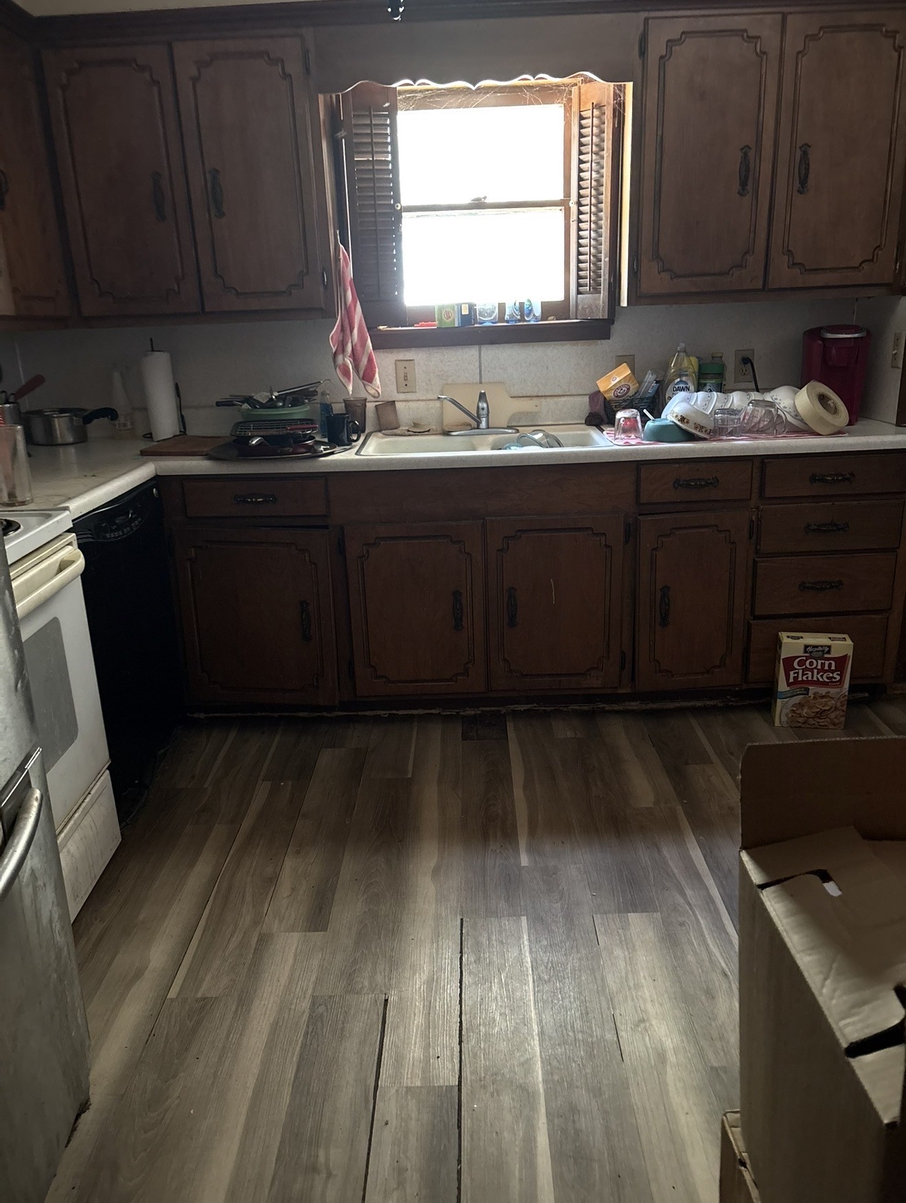 516 Walnut Street McLean, TX 79057 - Photo 5 of 12 a kitchen with a sink wooden cabinets and a stove