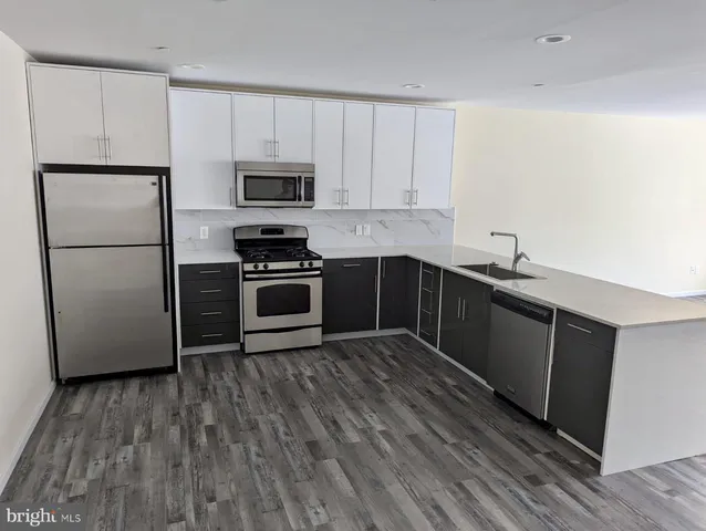 a kitchen with wooden cabinets and stainless steel appliances