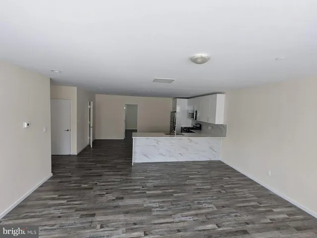a view of a kitchen with a sink and a stove top oven