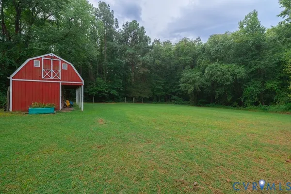 a view of a backyard with a garden and entertaining space