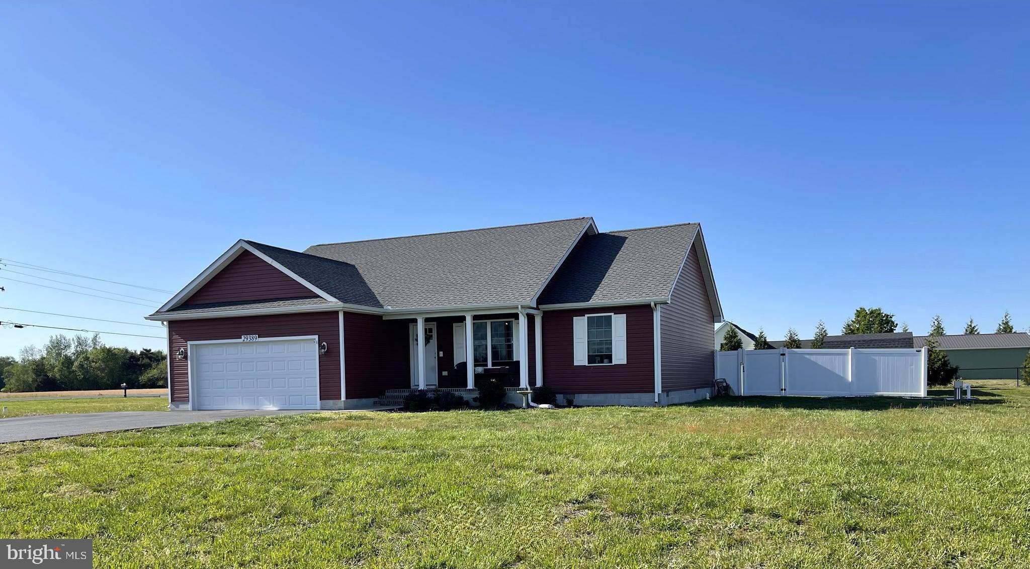 a front view of a house with a garden and yard