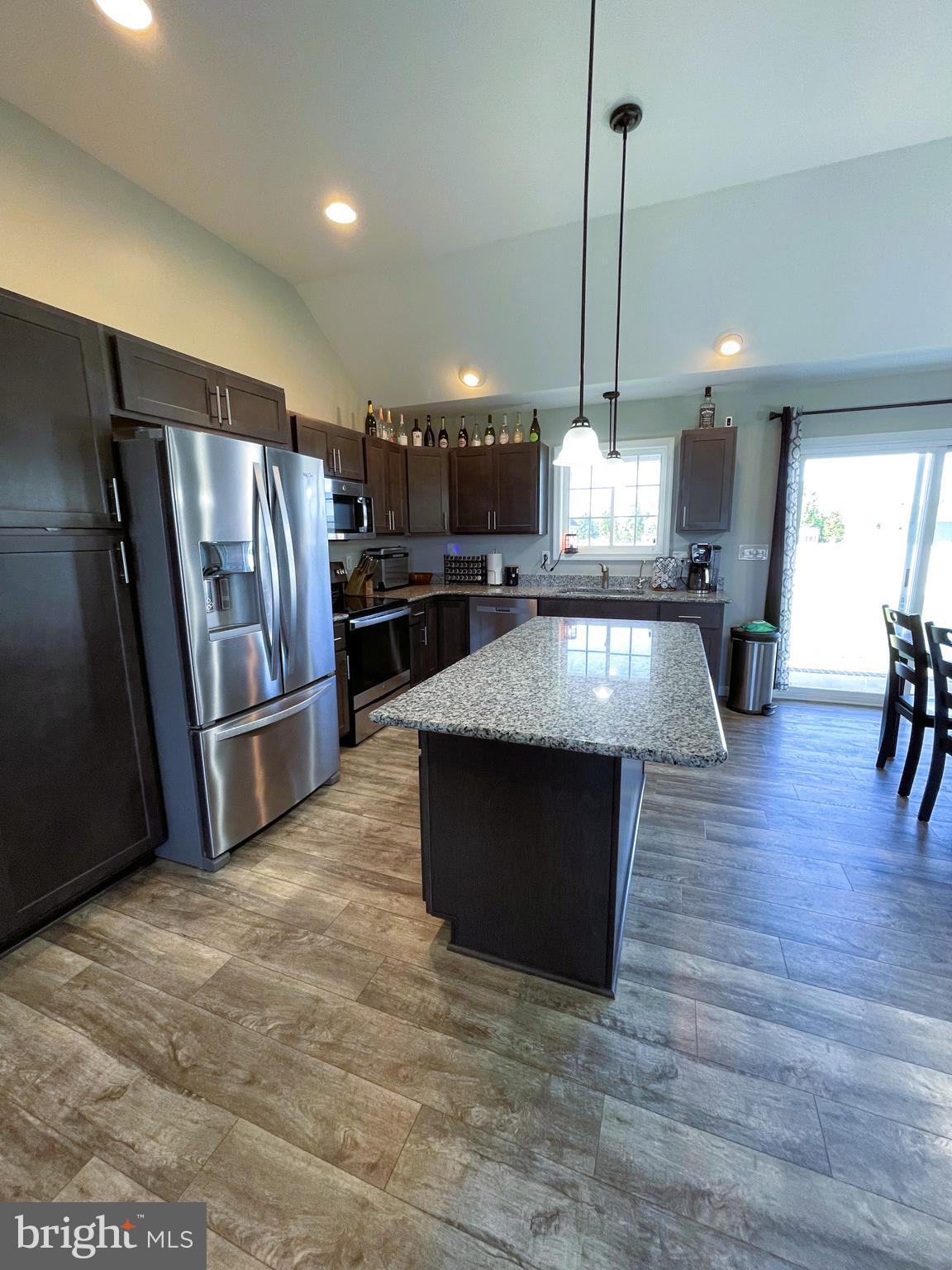 29389 Eagle Point Drive Seaford, DE 19973 - Photo 11 of 42 a kitchen with stainless steel appliances granite countertop a refrigerator a sink a stove and a wooden floors