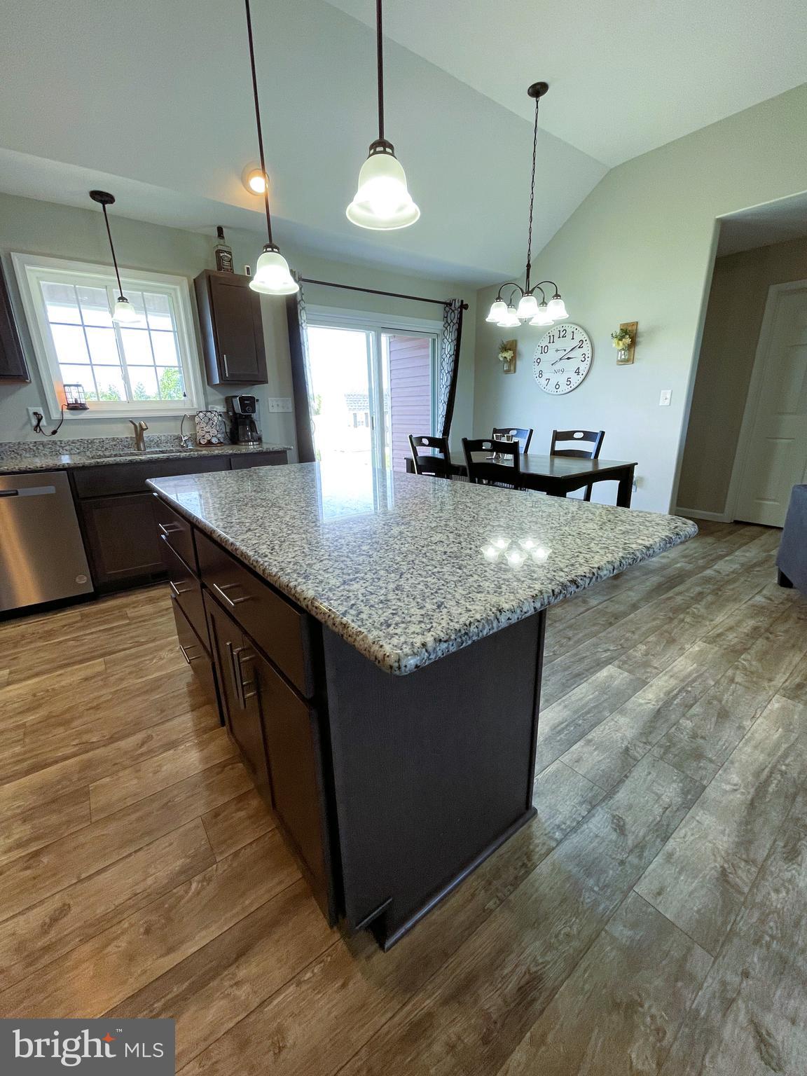 29389 Eagle Point Drive Seaford, DE 19973 - Photo 12 of 42 a kitchen with kitchen island granite countertop a sink a counter top space a stove and a refrigerator