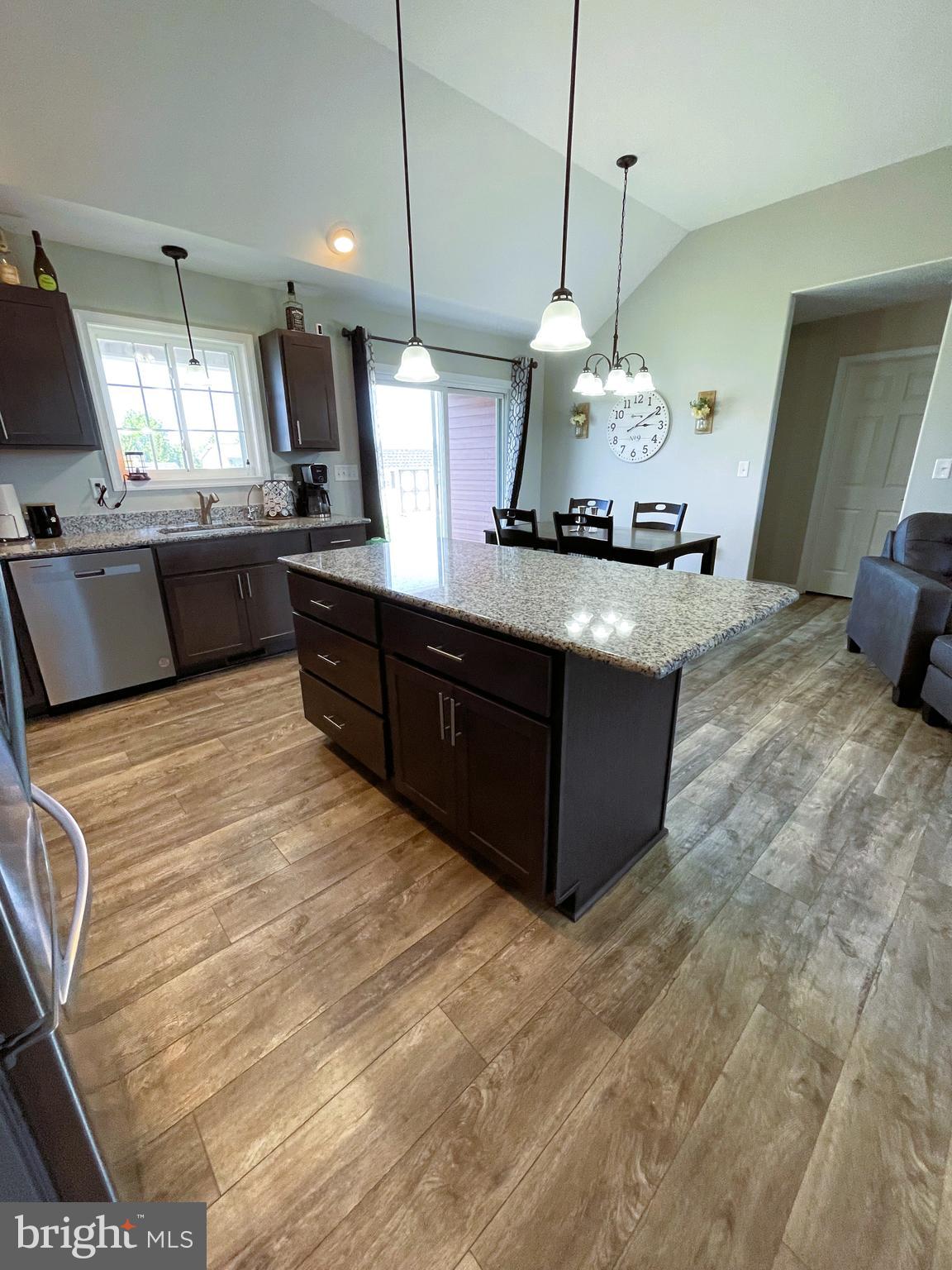 29389 Eagle Point Drive Seaford, DE 19973 - Photo 13 of 42 a kitchen with stainless steel appliances granite countertop a sink a stove and a wooden floors