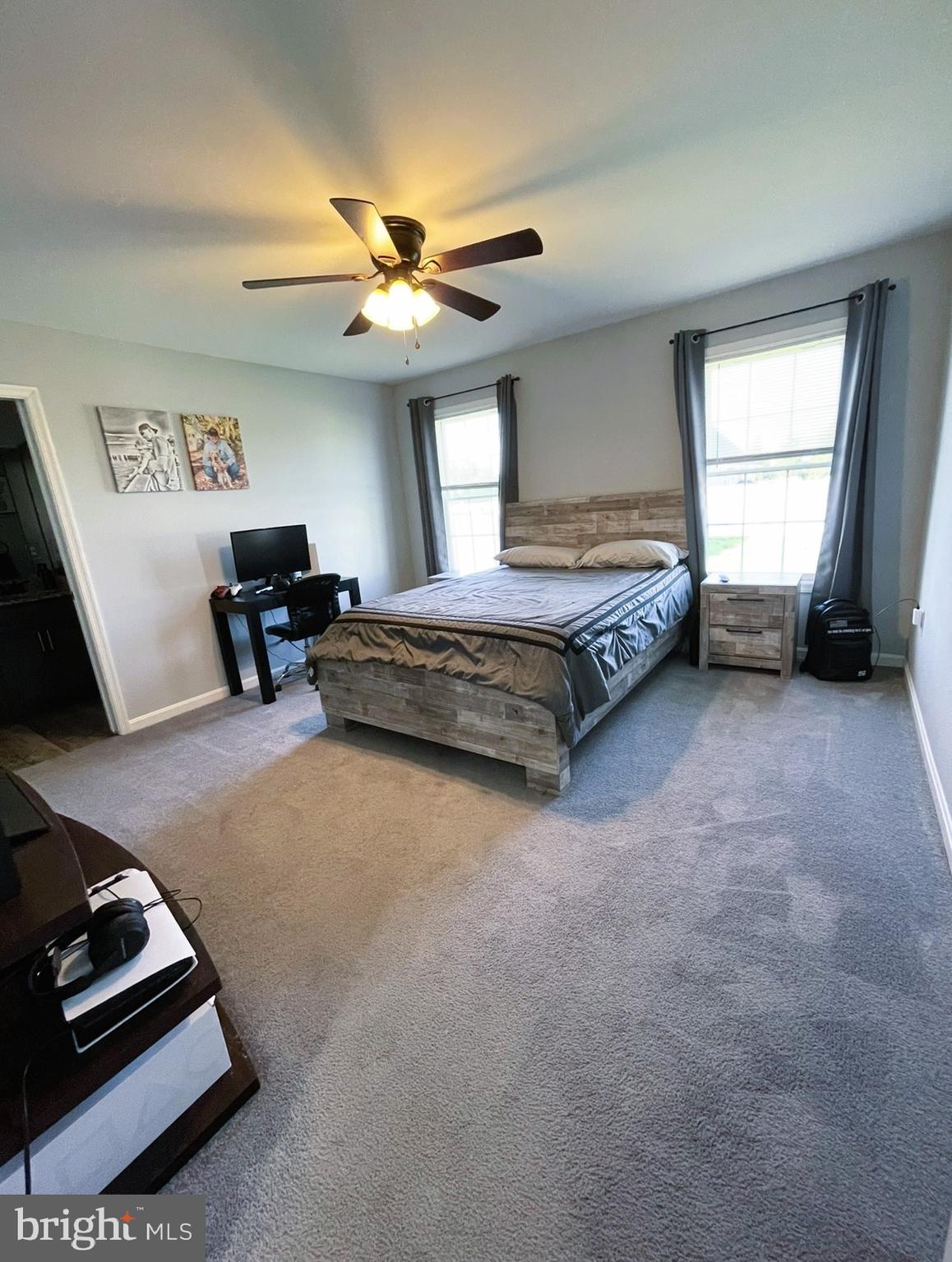 29389 Eagle Point Drive Seaford, DE 19973 - Photo 18 of 42 a spacious bedroom with a bed and a chandelier