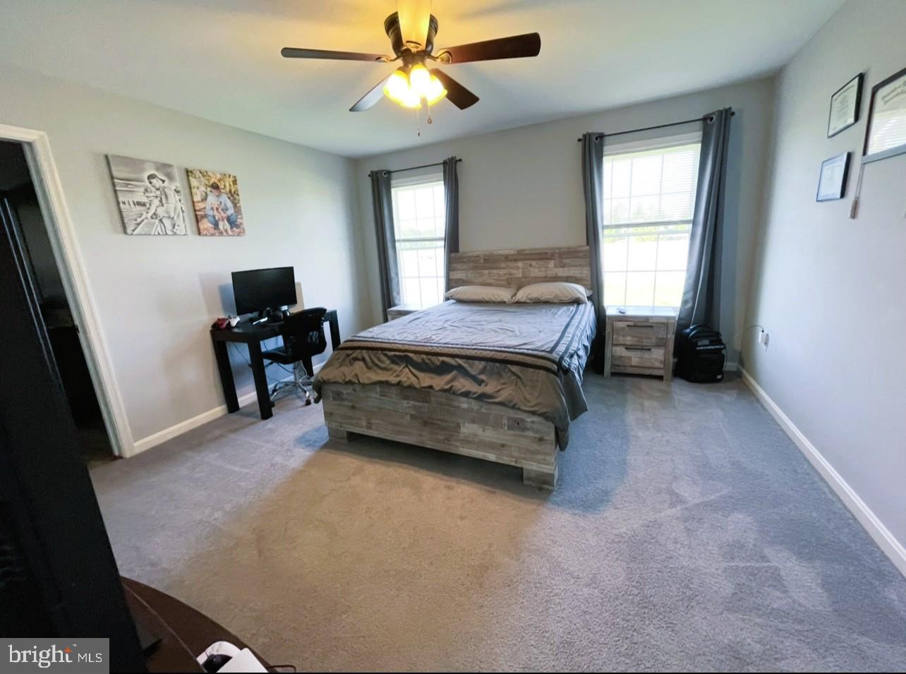 29389 Eagle Point Drive Seaford, DE 19973 - Photo 19 of 42 a bedroom with a bed and a chandelier