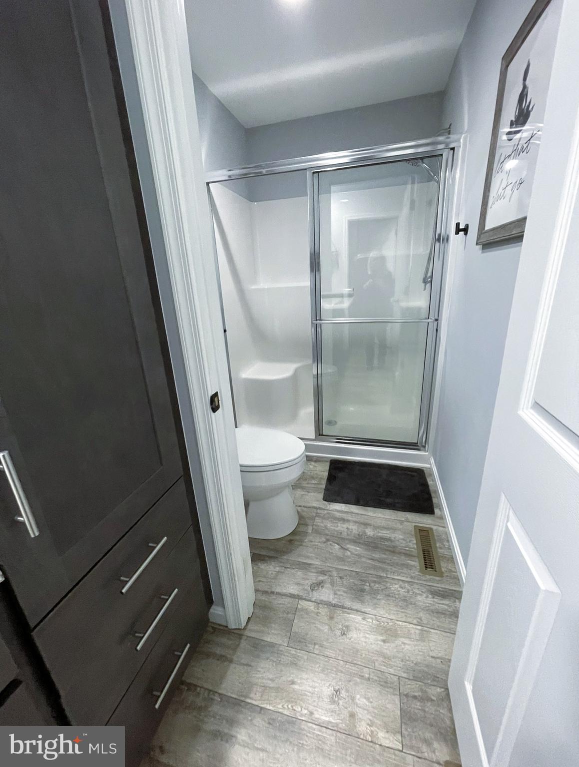 29389 Eagle Point Drive Seaford, DE 19973 - Photo 25 of 42 a bathroom with a glass door shower and toilet