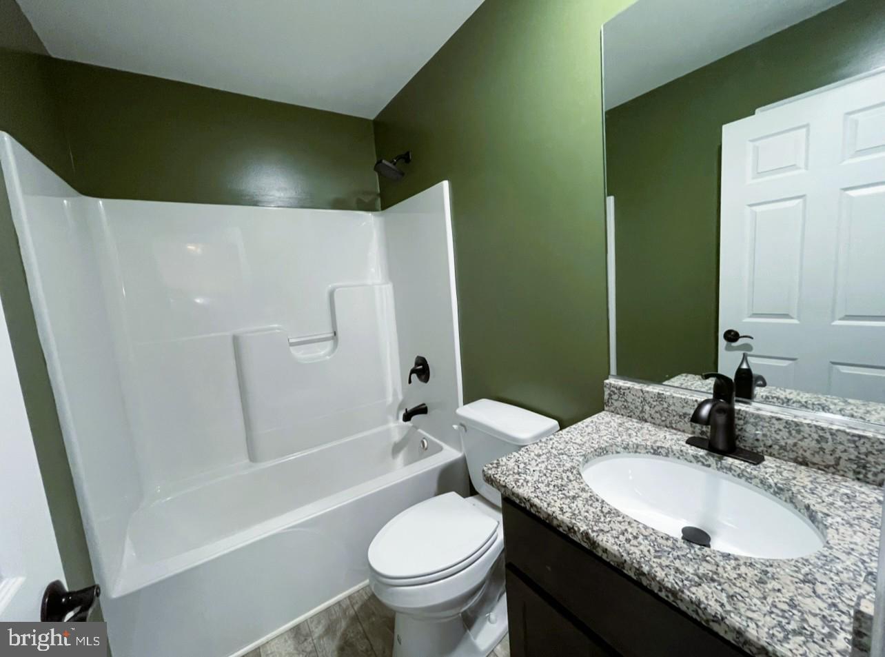 29389 Eagle Point Drive Seaford, DE 19973 - Photo 32 of 42 a bathroom with a granite countertop sink toilet and shower