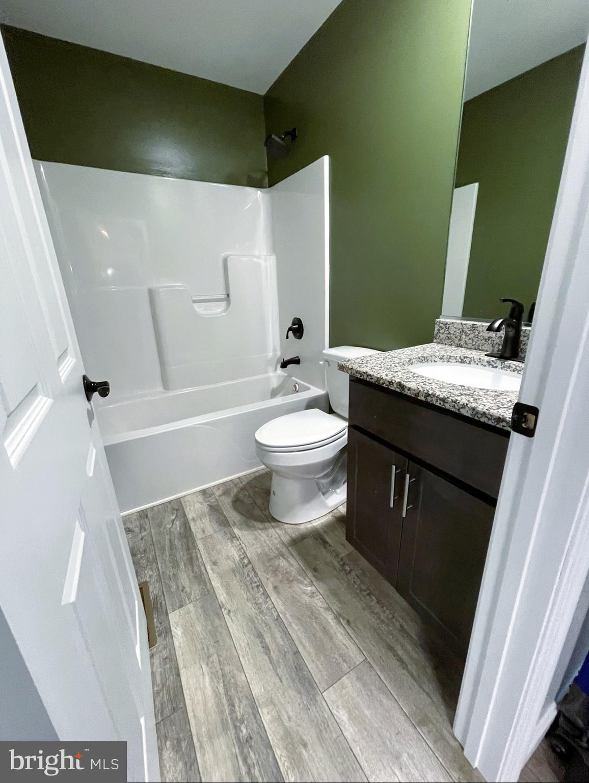 29389 Eagle Point Drive Seaford, DE 19973 - Photo 33 of 42 a bathroom with a granite countertop sink toilet and shower