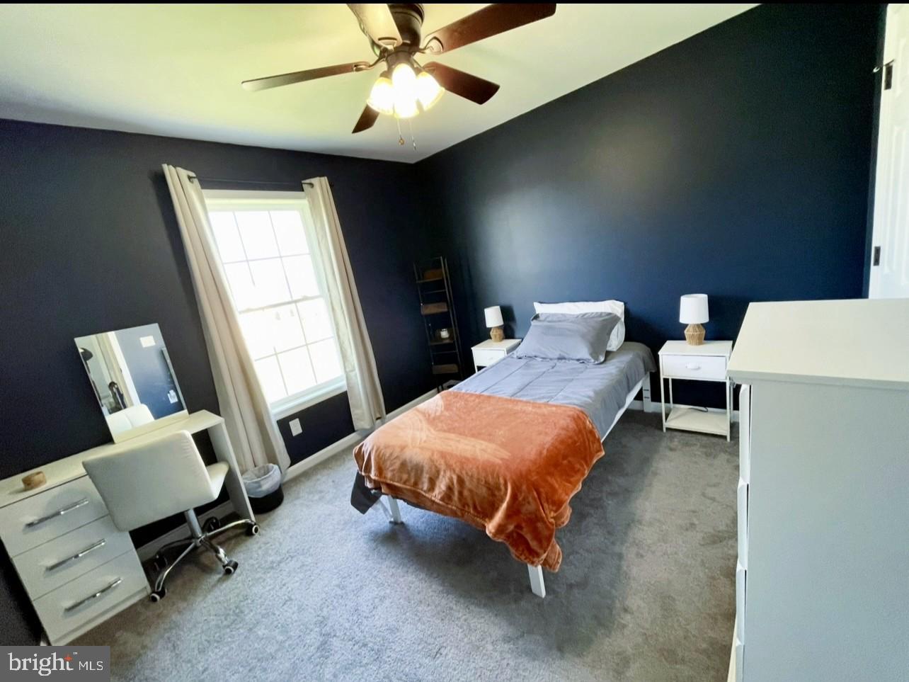 29389 Eagle Point Drive Seaford, DE 19973 - Photo 35 of 42 a bedroom with a bed and a chandelier