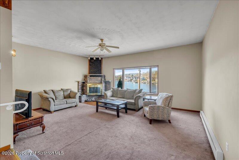 1228 Lake Road Factoryville, PA 18419 - Photo 25 of 43 a living room with furniture and a chandelier