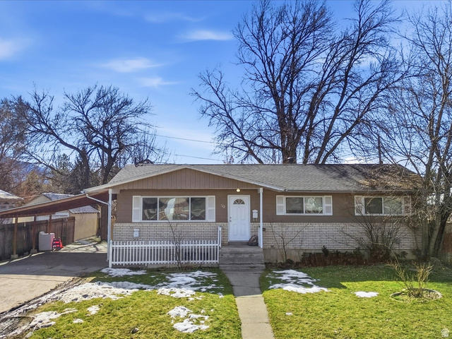 322 East 900 North Logan, UT 84321 - Photo 2 of 43 View of front of home with a shingled roof, driveway, and covered porch