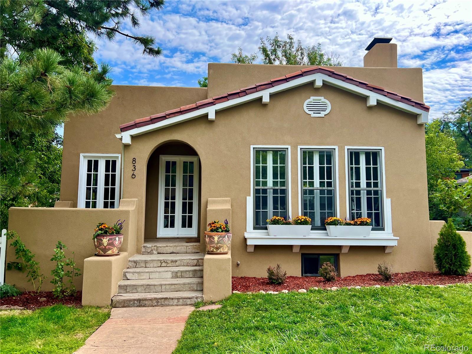 a front view of a house with garden
