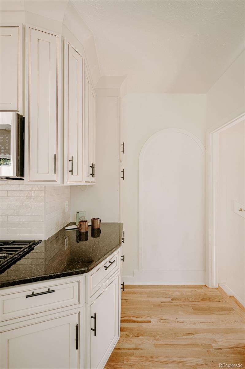 836 9th Street Boulder, CO 80302 - Photo 14 of 32 a kitchen with granite countertop white cabinets and sink
