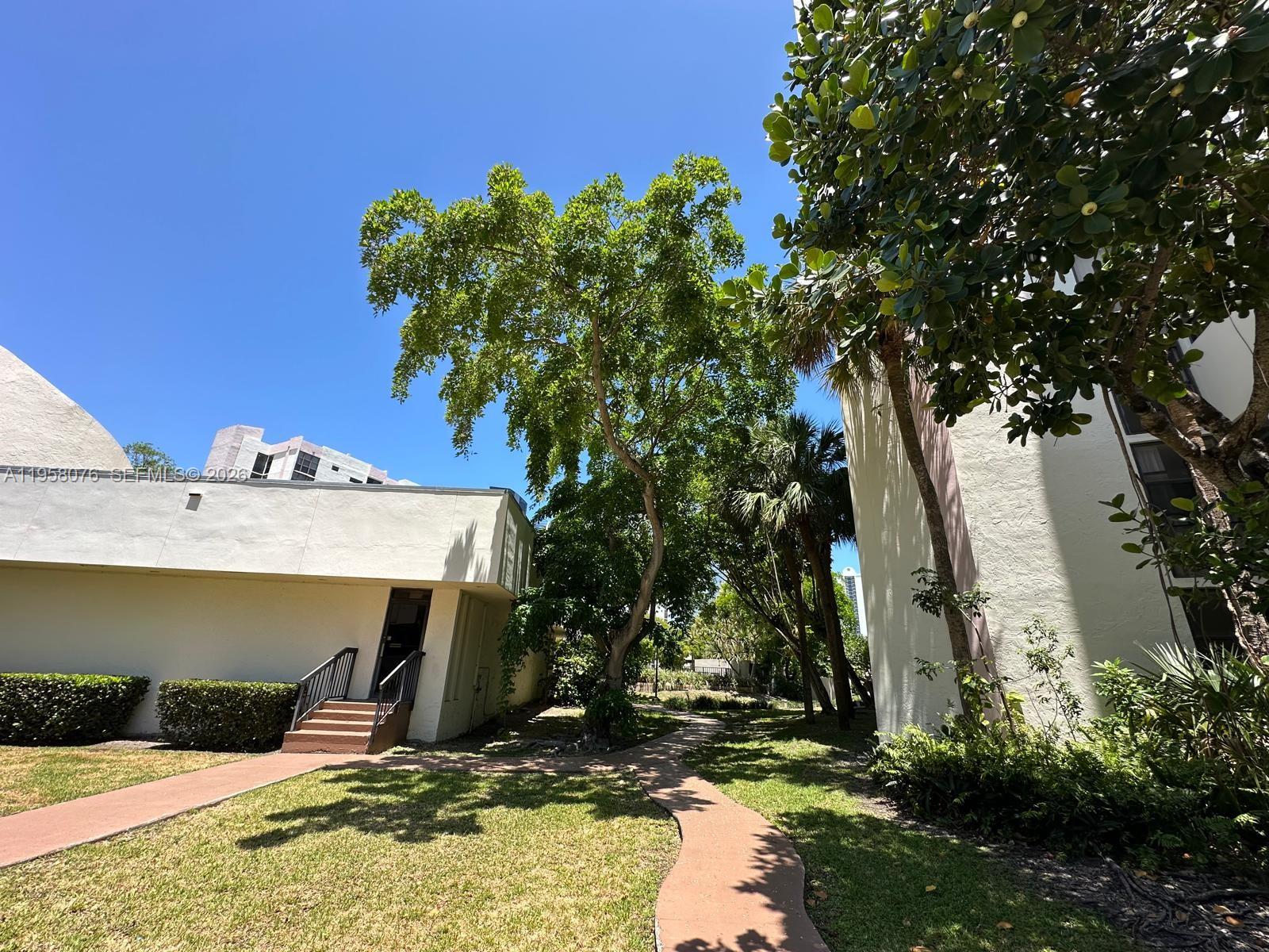 16919 North Bay Road, Unit 617 Sunny Isles Beach, FL 33160 - Photo 26 of 37 a view of a house with a yard