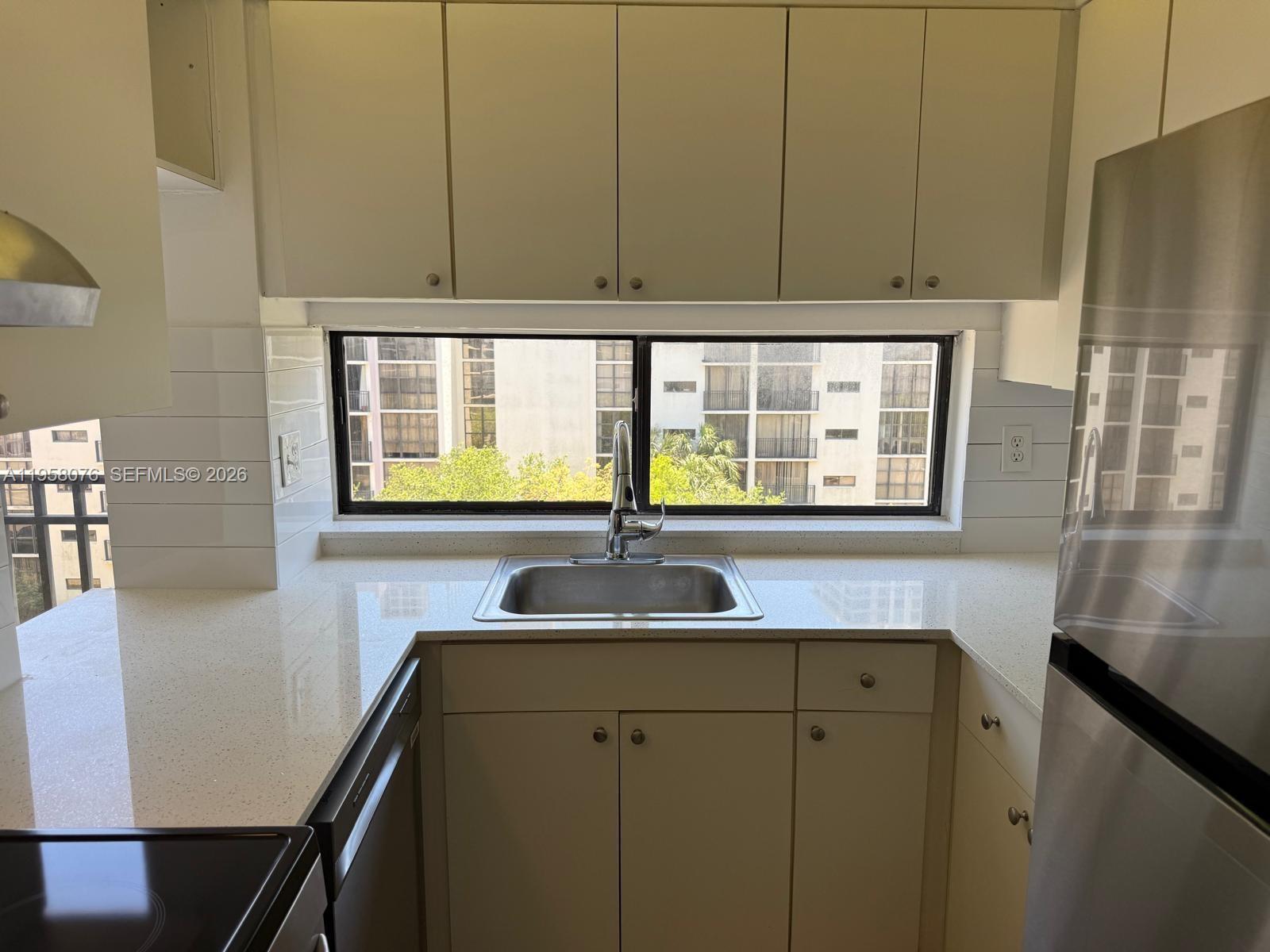 16919 North Bay Road, Unit 617 Sunny Isles Beach, FL 33160 - Photo 5 of 37 a kitchen with a sink and cabinets