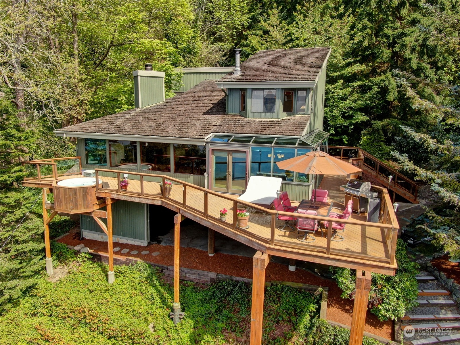 an aerial view of a house with roof deck front of house
