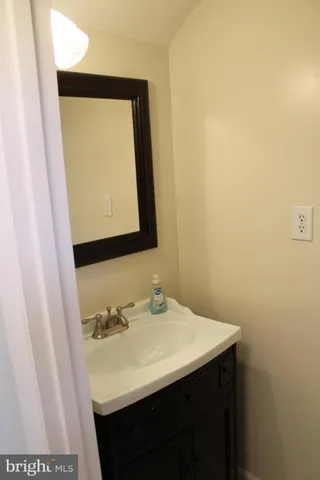 a bathroom with a sink a mirror and vanity