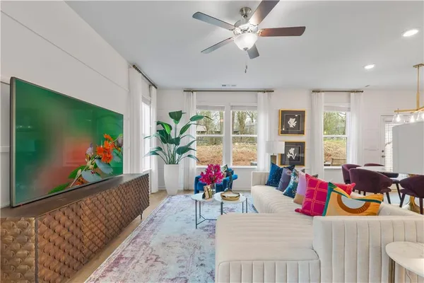 a living room with furniture dining room and a flat screen tv