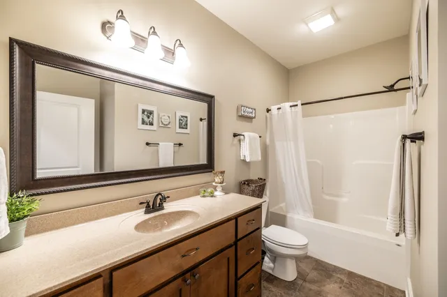 a kitchen with stainless steel appliances granite countertop sink stove and refrigerator