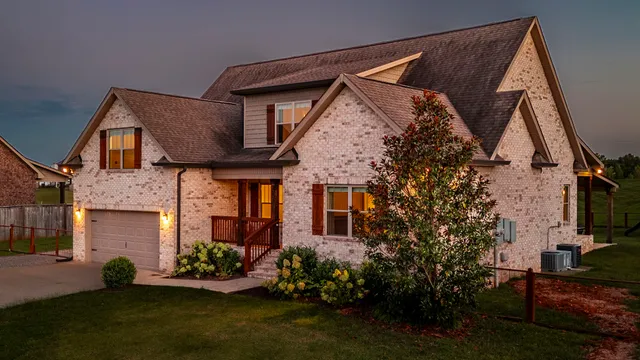 a front view of a house with a garden and plants
